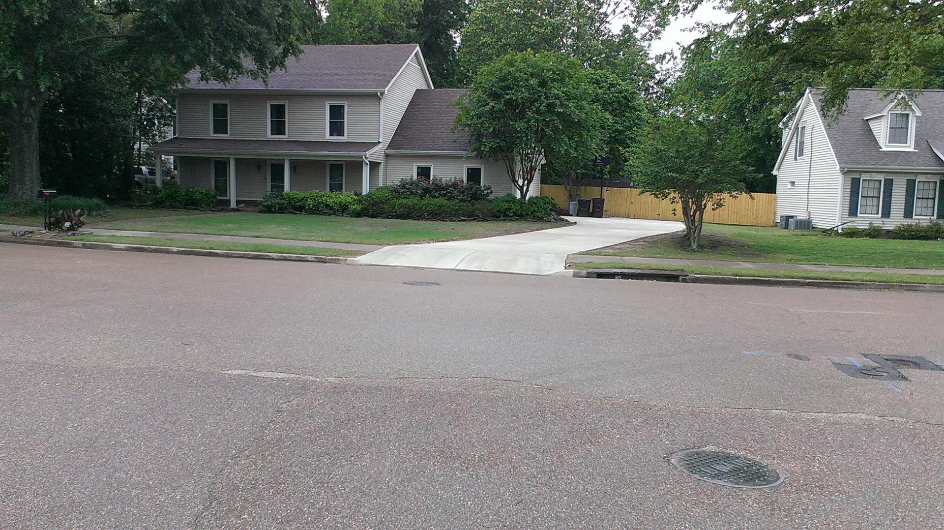 A driveway apron correctly constructed with a curb cut permit.